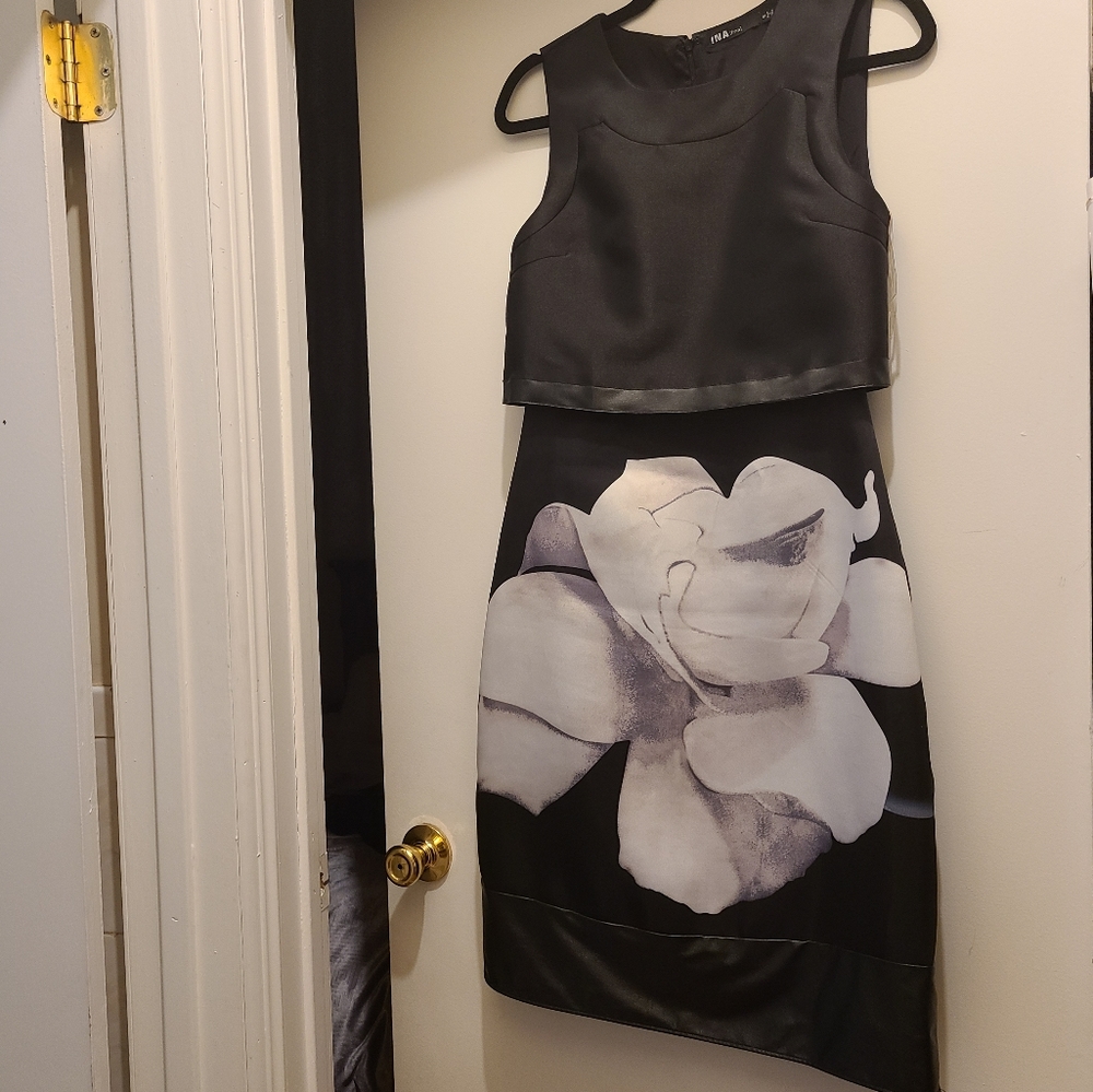 Elegant black sleeveless evening dress. Leather trimming. Knee length. Flower